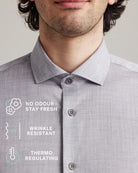 Collar detail of a gray merino wool shirt with text highlighting features like no odor, wrinkle resistance, and thermo regulation.