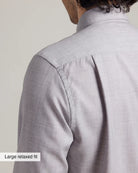 close up of the shoulder, yoke and back pleat on a merino wool dress shirt in light gray heather color