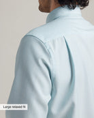 shoulder and back pleat detail of a relaxed fit merinowool dress shirt in light blue stripe pattern 
