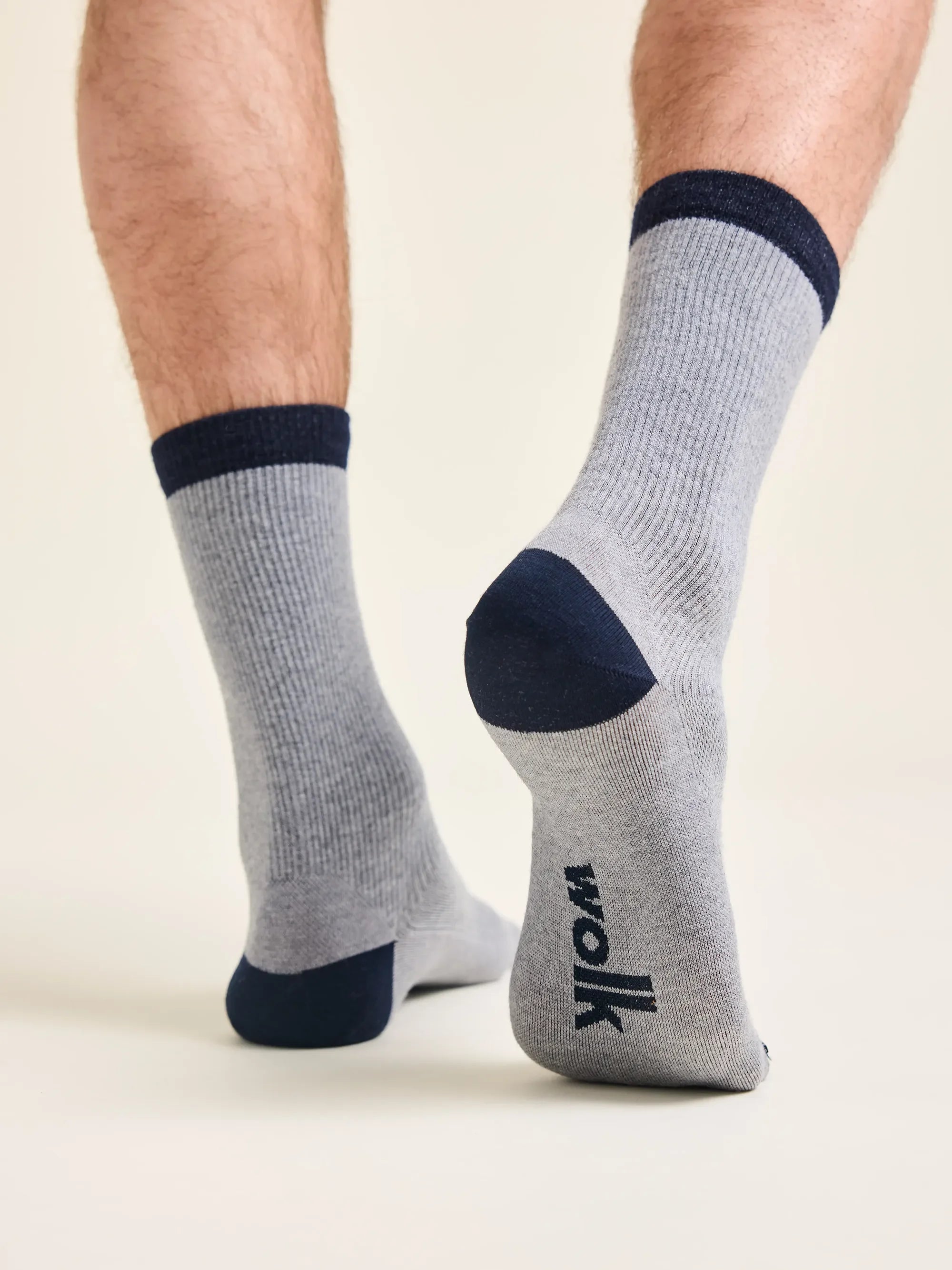 Grey merino wool socks with blue too, heel and cuff. Rib texture and Wolk logo on sole