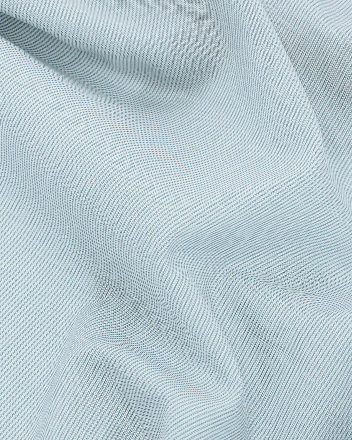Close-up 100% woven merinowool shirting fabric in a light blue stripe pattern