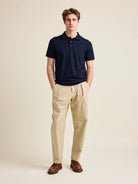 Man wears short sleeve merino wool polo from Wolk in dark navy blue color with 3 buttons and regular collar.