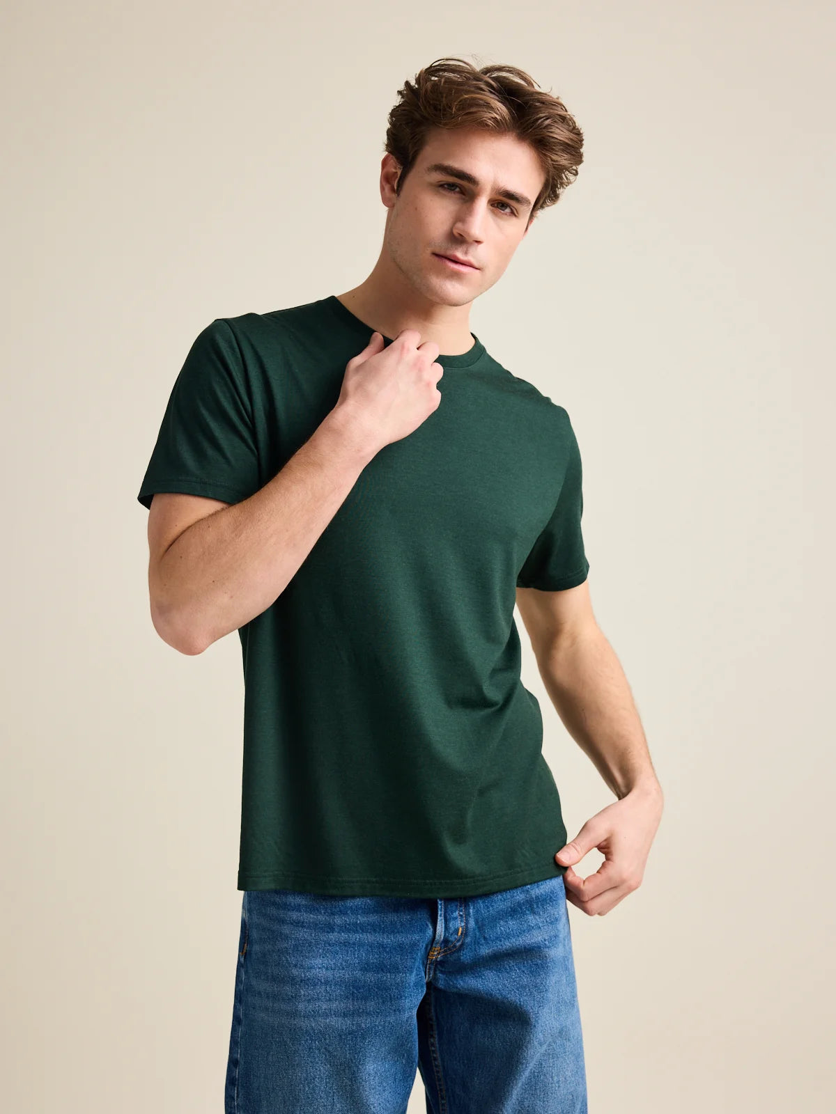 Studio shot of a men's merino wool T-shirt in dark green, designed by Wolk.