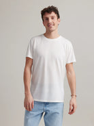 Man wearing white men's merino wool T-shirt with round neck and short sleeves made in Europe