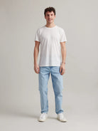 Studio shot of a men's white merino wool T-shirt from Wolk, displaying the front profile and sleek design.