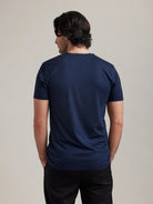 Backside of Men’s T-shirt in merino wool in navy with V neck collar and short sleeves by Wolk.