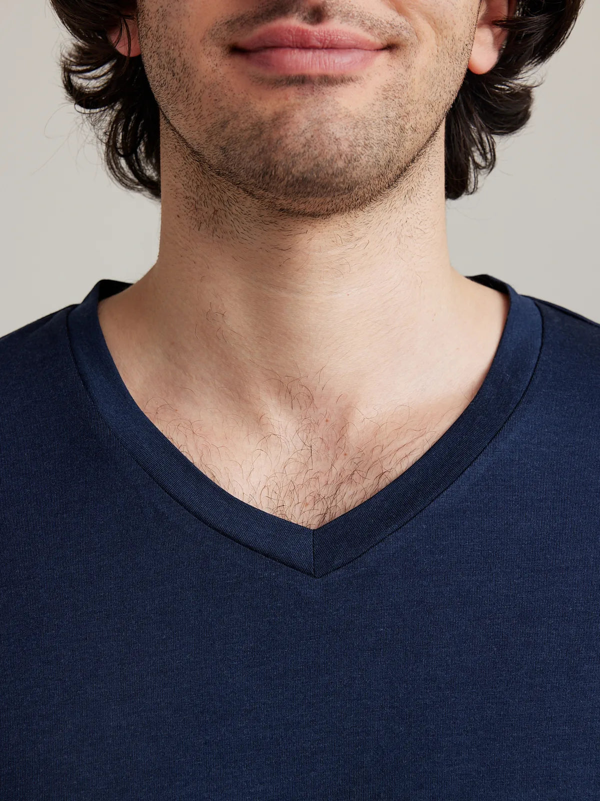 Detail shot of the navy V neck collar from Wolk's men's merino wool T-shirt collection.