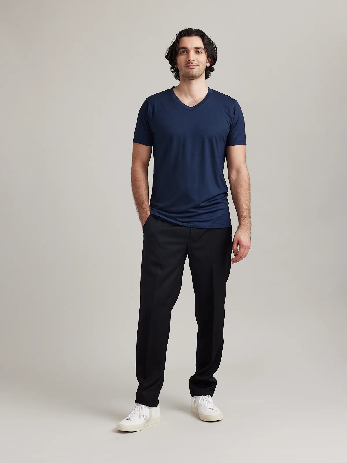 Wolk's navy men's merino wool T-shirt in a studio setting, showcasing V-neck design.