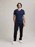Wolk's navy men's merino wool T-shirt in a studio setting, showcasing V-neck design.