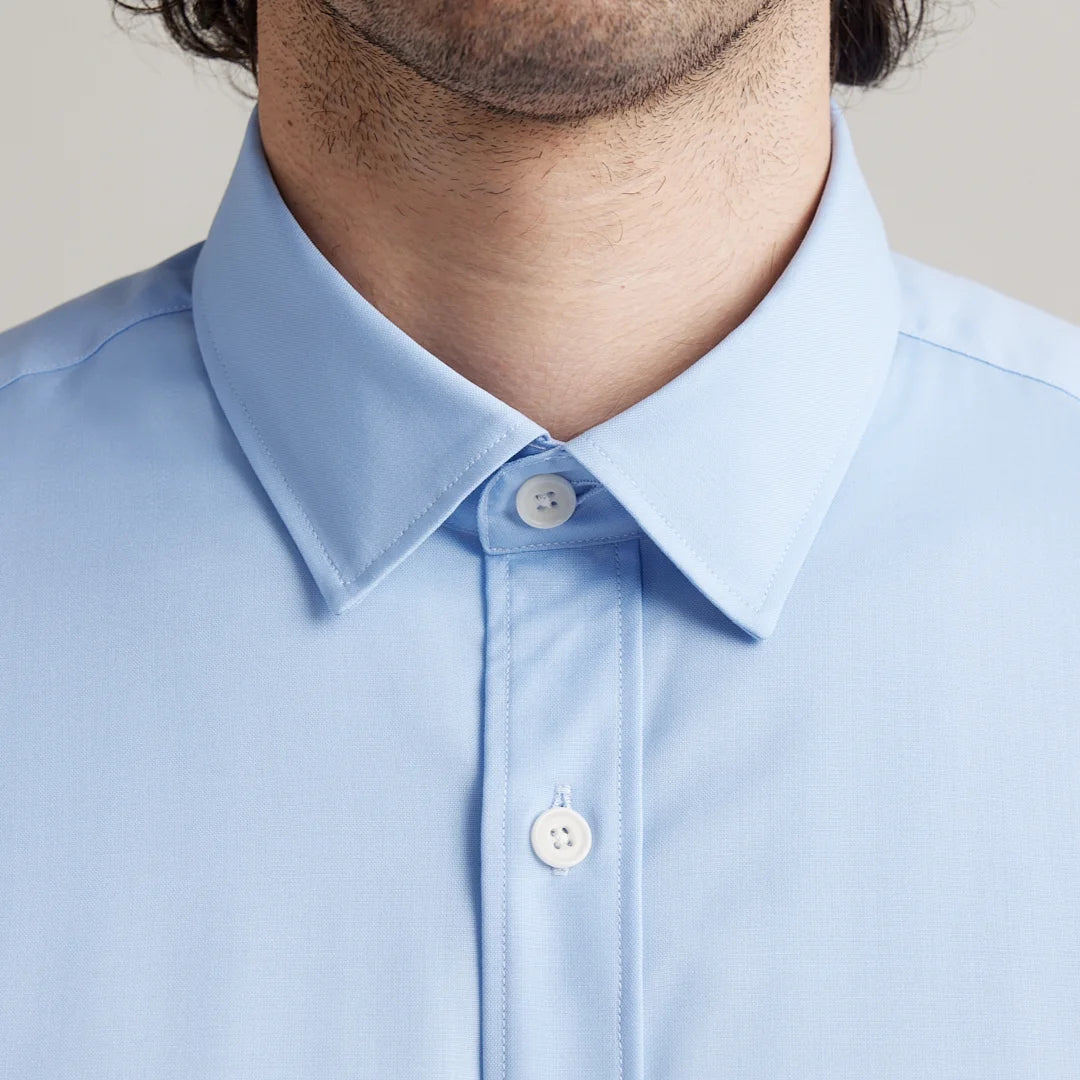 close up of light blue merino wool shirt with classic collar and white corozo buttons
