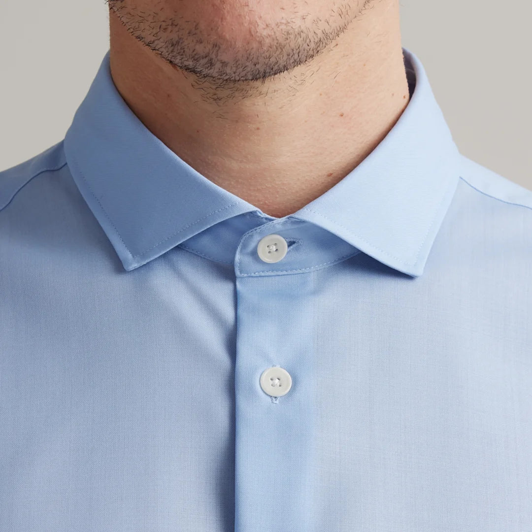 close up of light blue merino wool dressed shirt with Italian spread collar and white corozo buttons