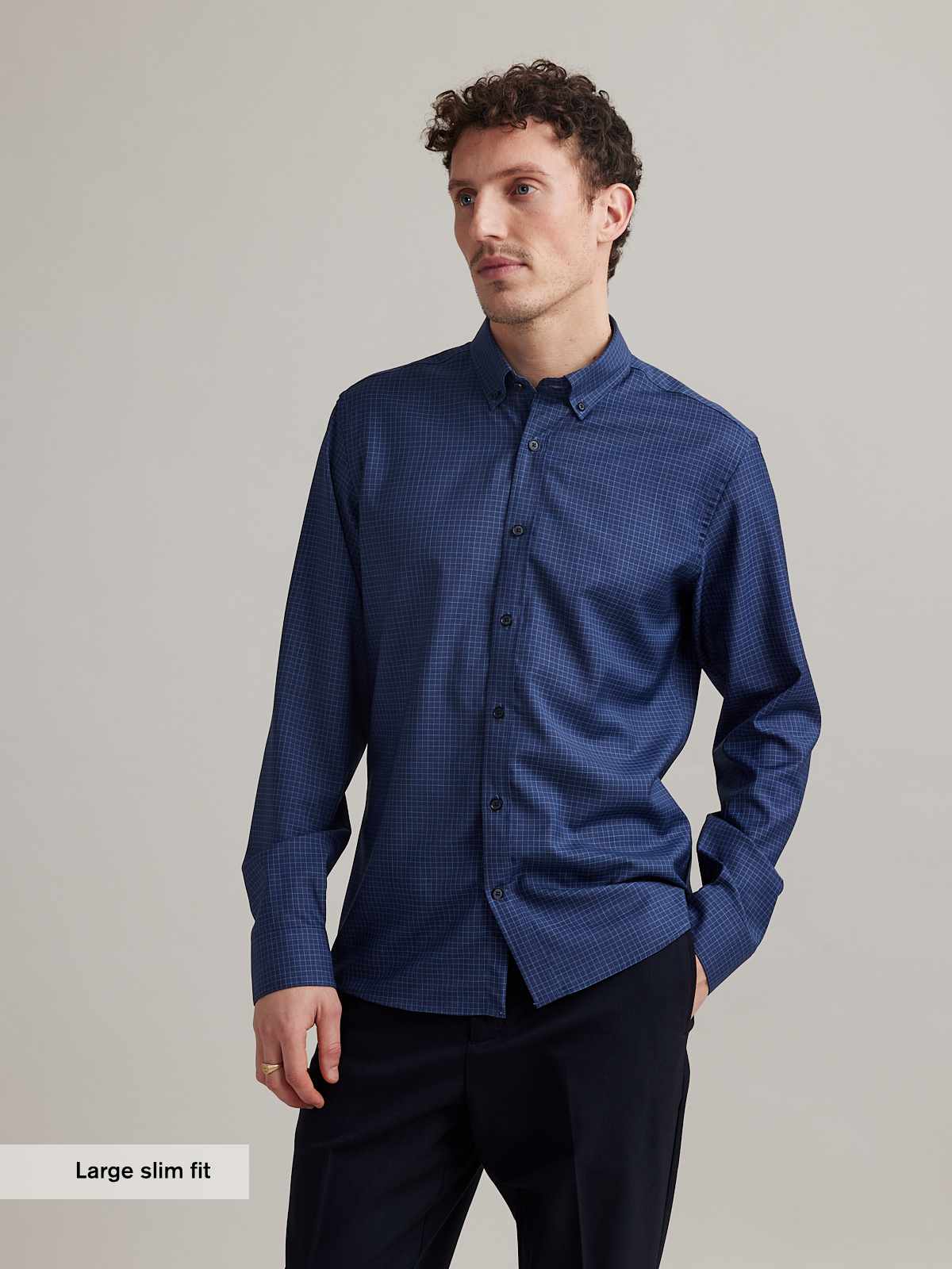 man wears Wolk merino shirt in blue color with small graph check and button down collar in slim fit