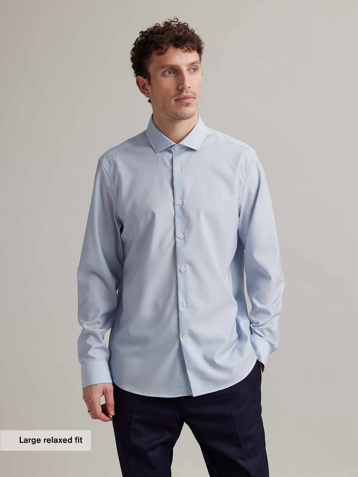 man wearing light blue merino shirt with spread collar in relaxed fit