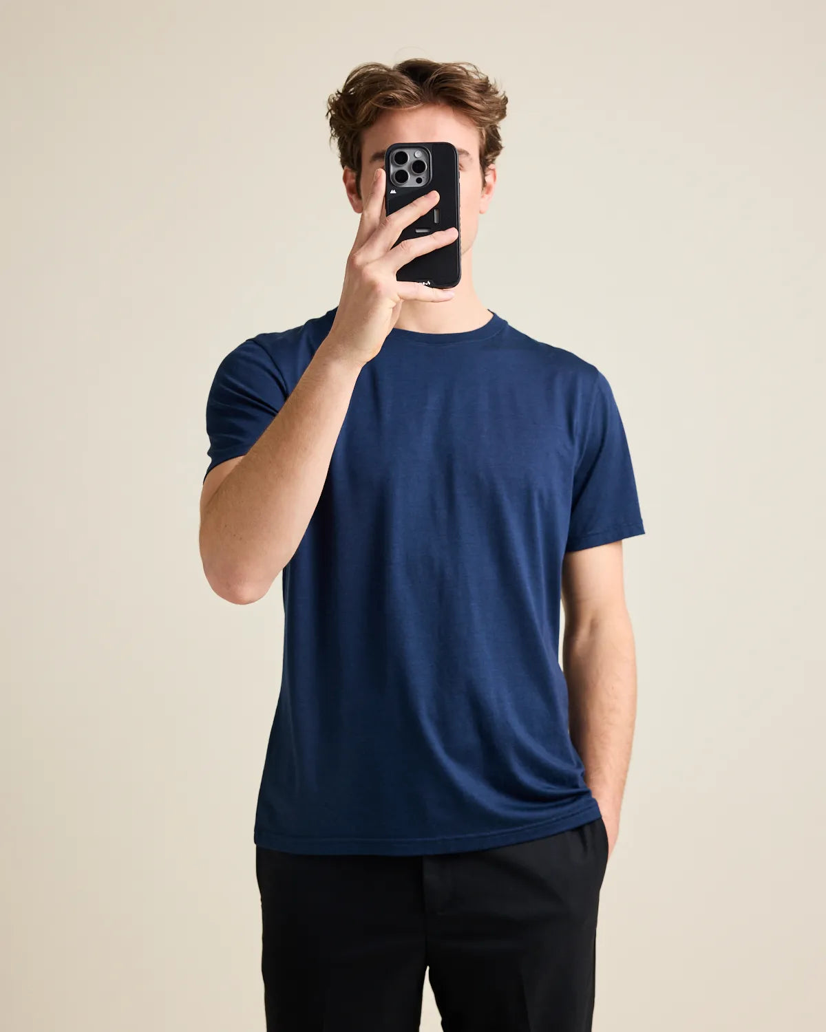 man taking a selfie wearing a navy merino t-shirt