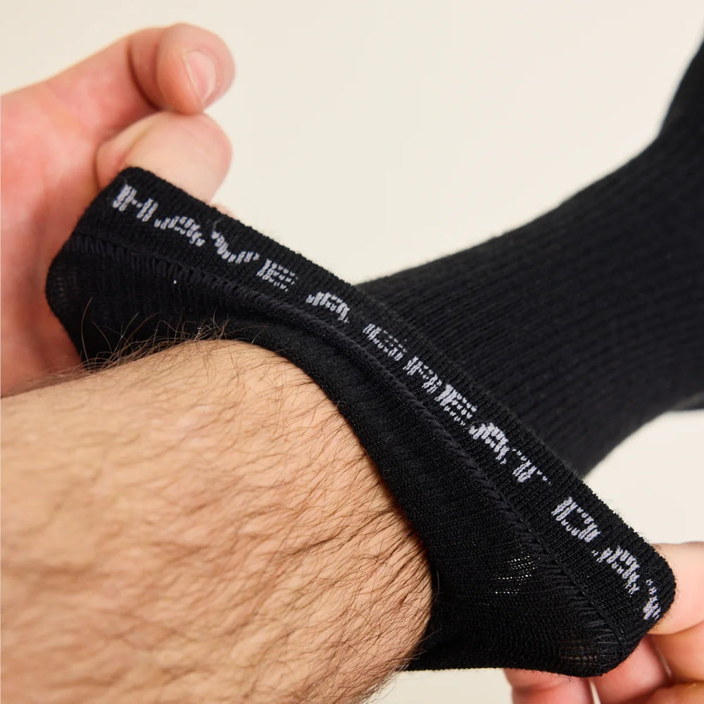 files/wolk_merino_sock_in_black_showing_rib_and_cuff_square.webp