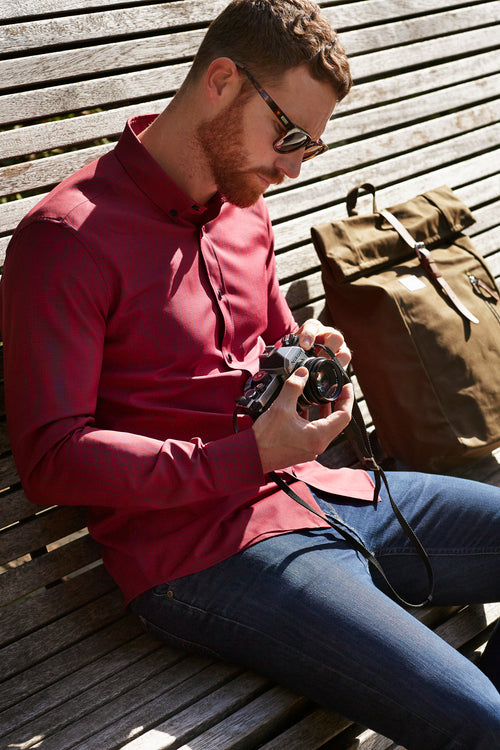 Wolk - man wearing a  merino shirt with button down collar in red navy mini gingham and long sleeves