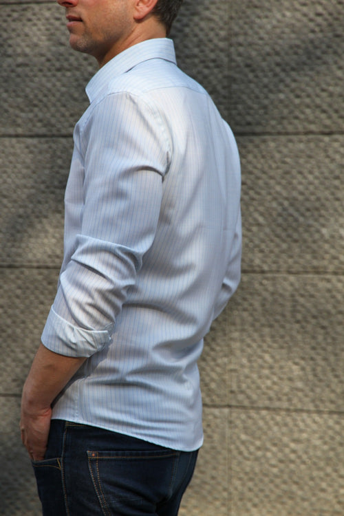 side view of men wearing merino wol shirt in light blue pinstripe