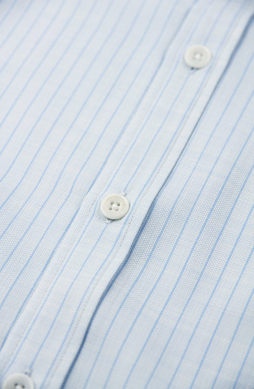 White corrozo buttons on merino shirt in light blue pinstripe