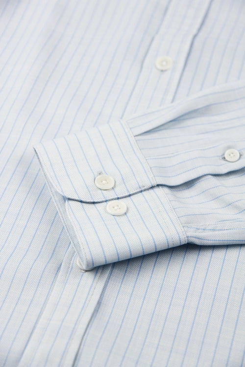 cuff detail off a merino shirt from Wolk with light blue pinstripes