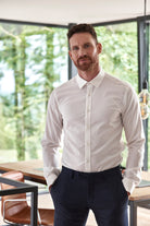 Man wearing a long sleeve merino dress shirt in white