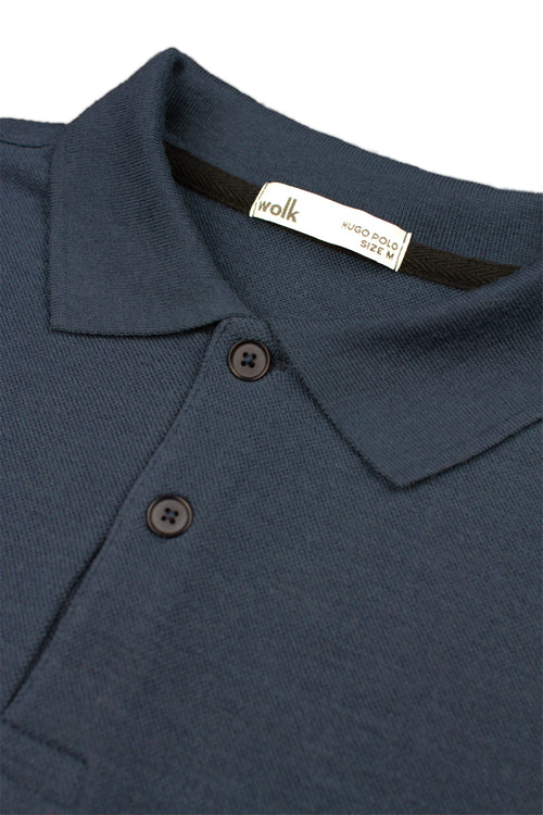 detail of rib collar and corozo buttons on merino wool polo from Wolk 