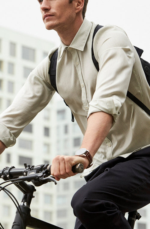 man on bike wearing a Wolk merino wool shirt in black stripe with long sleeves
