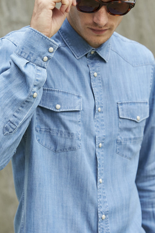 Wolk- man wearing Tencel denim shirt in washed indigo color
